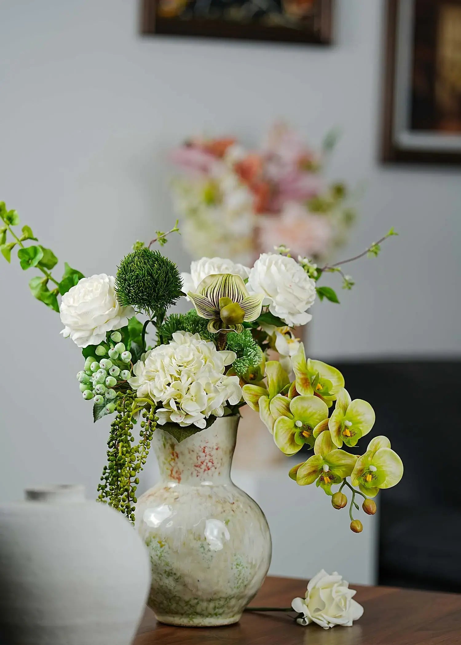 Deluxe white and green artificial flower arrangement featuring orchids and roses displayed in a modern living room interior – Everblooma luxury faux florals