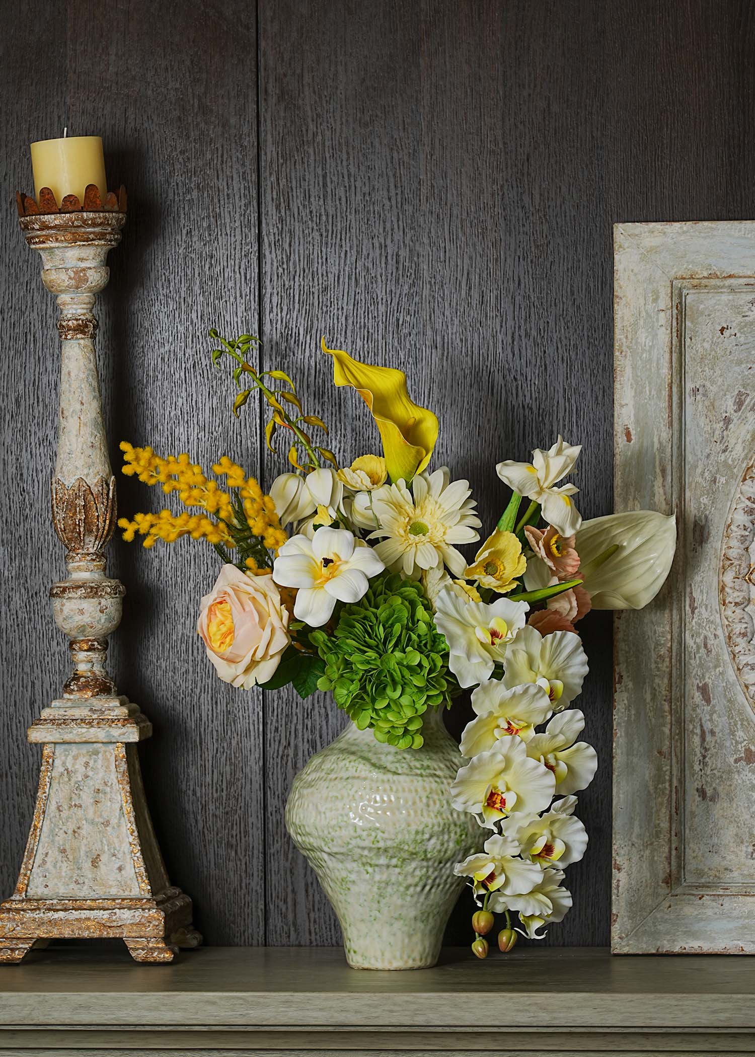 Real Touch White Lilies and Faux Anthurium floral arrangement in a ceramic vase, styled against dark wood background with vintage candle stand — elegant Everblooma home décor.