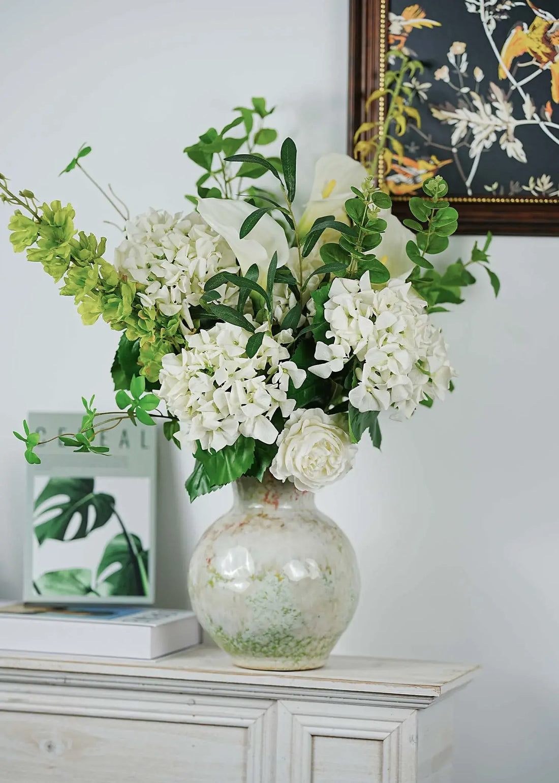 Green Serenity faux floral arrangement with white hydrangeas and calla lilies styled in a cozy living room interior – Everblooma home décor flowers