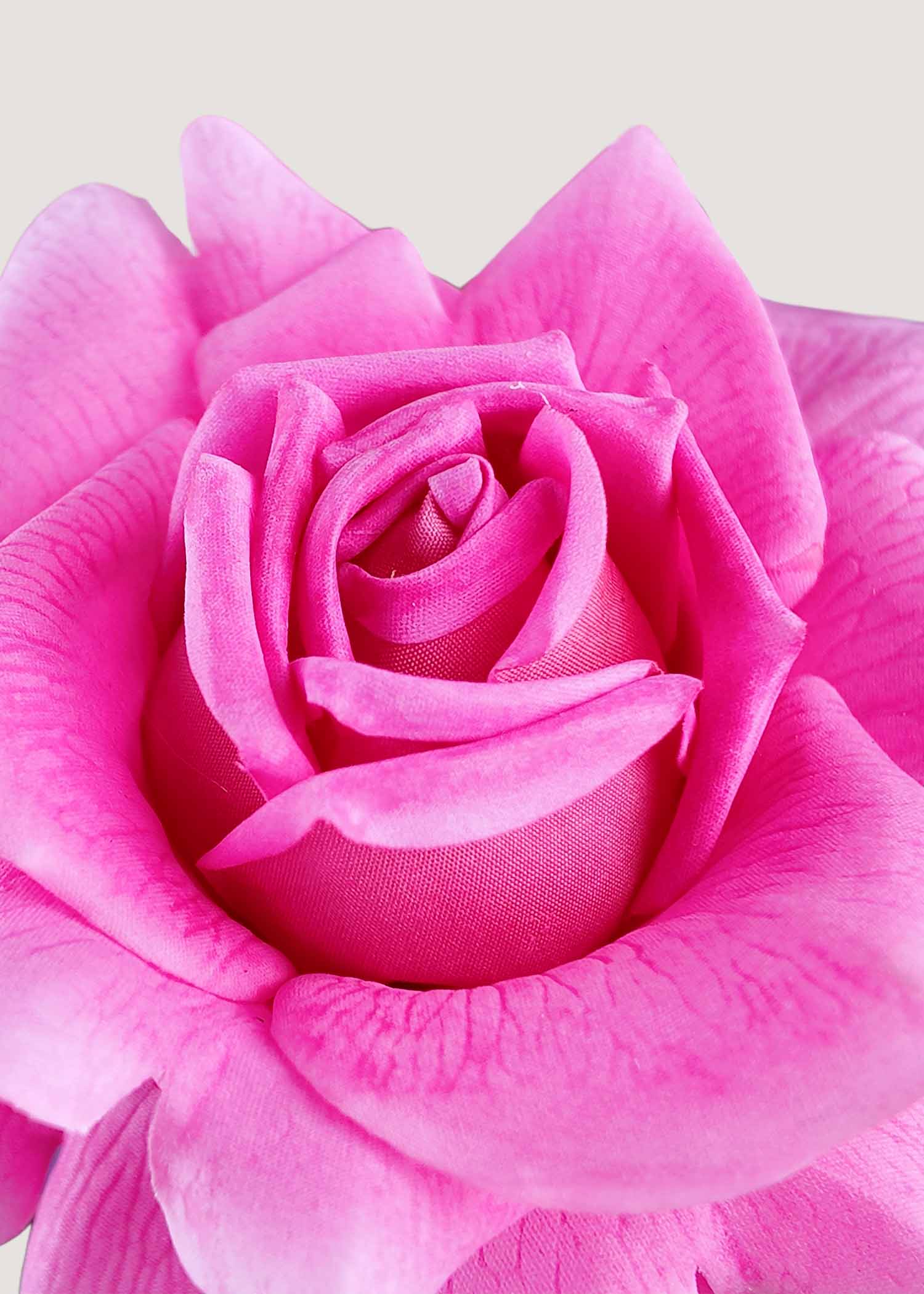 Close-up detail of luxury faux floral arrangement highlighting vibrant pink artificial rose with orchids and calla lilies
