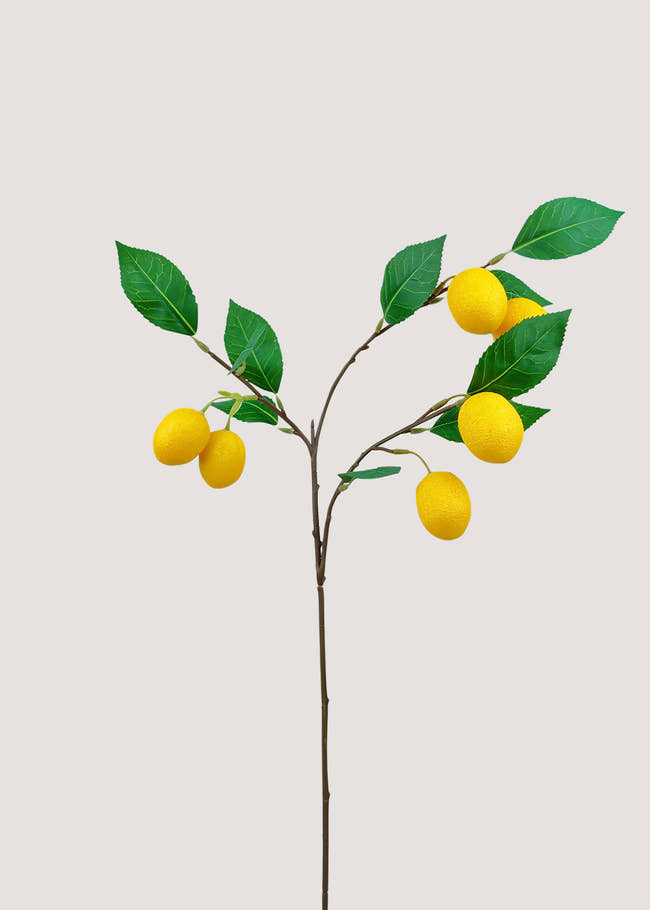 Artificial lemon branch with bright yellow fruit and green leaves