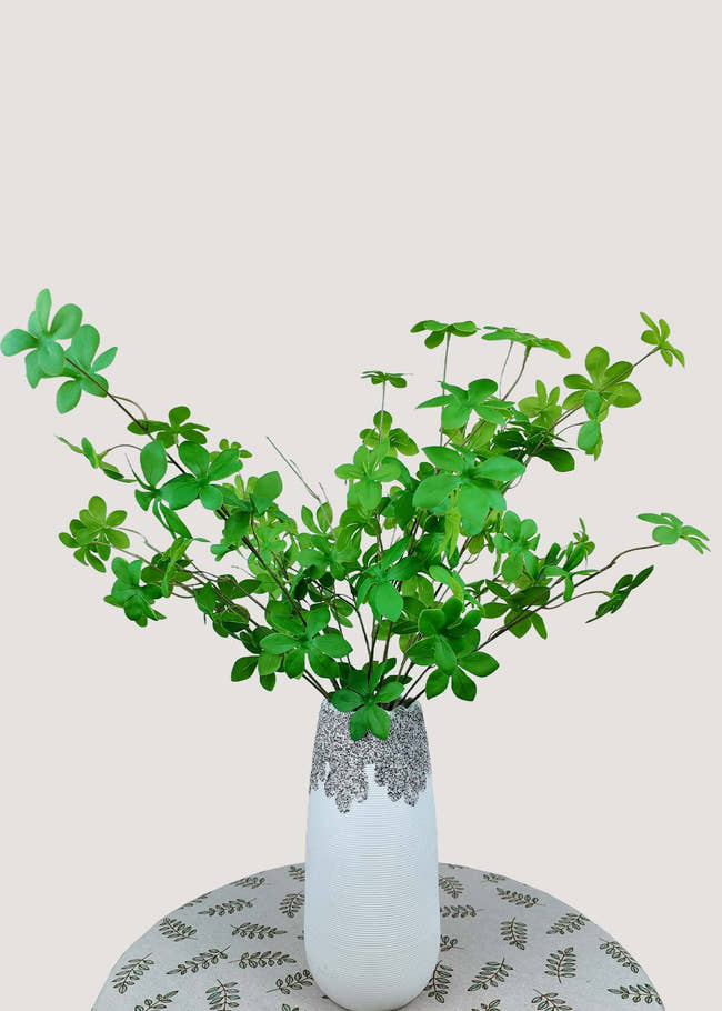 Lifelike artificial green leaf stem arrangement in vase for home decor