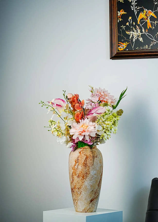 Peach blush artificial flower arrangement featuring dahlias, orchids, and white lilies styled in a rustic ceramic vase – Everblooma faux floral décor