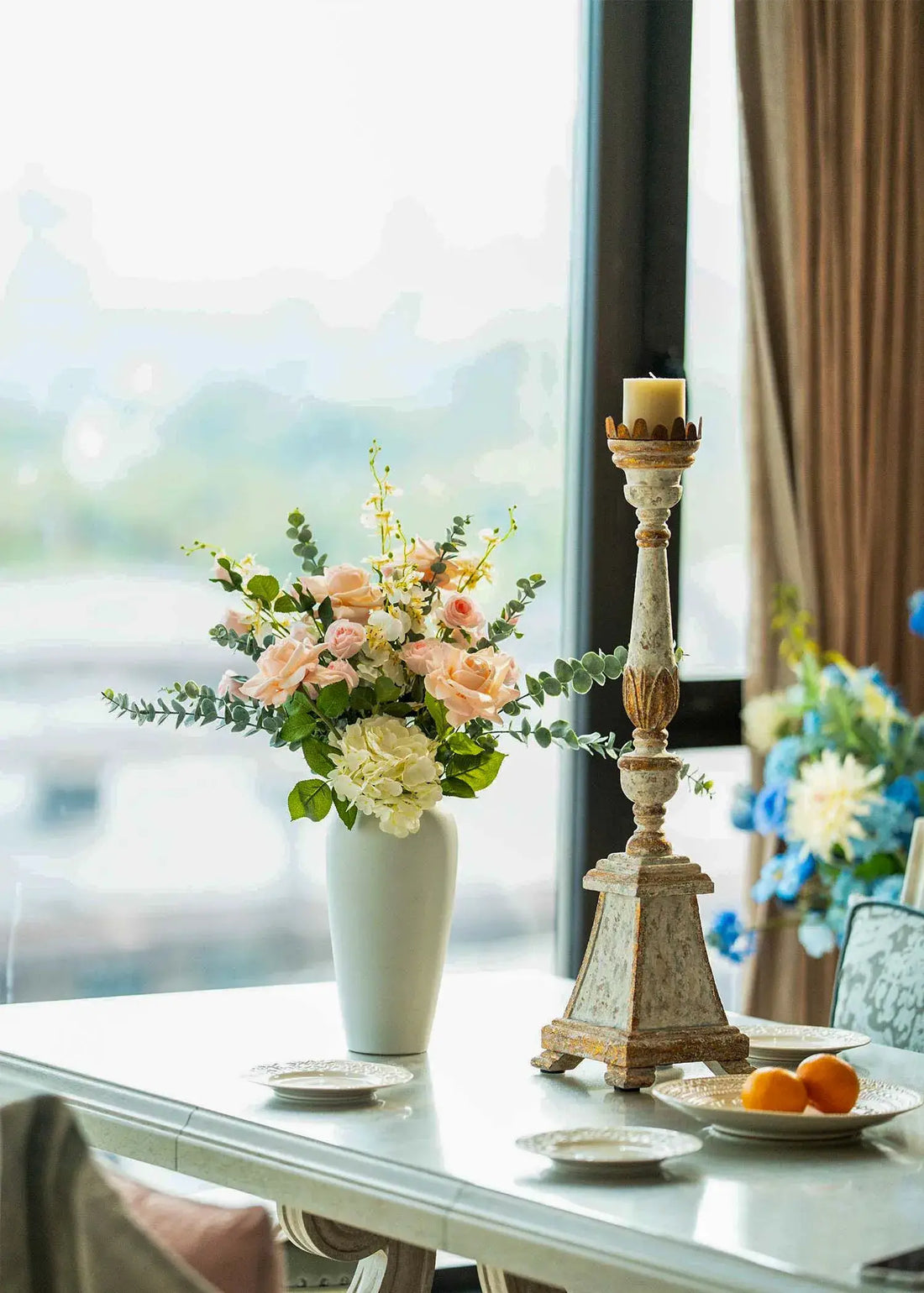 Real Touch blush roses and white hydrangea faux floral arrangement in a ceramic vase on a bright dining table, elegant home decor centerpiece.
