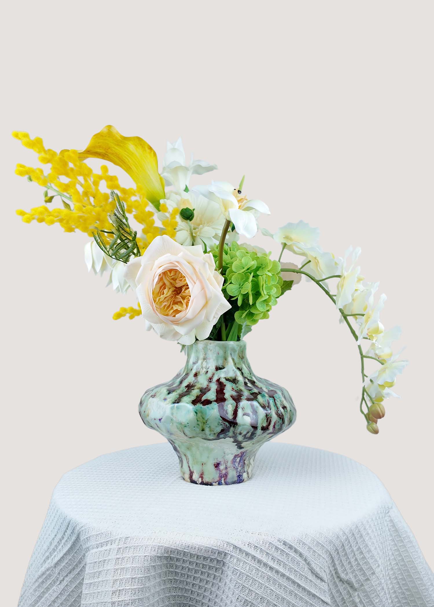 Real touch white lilies with faux anthurium floral arrangement front view