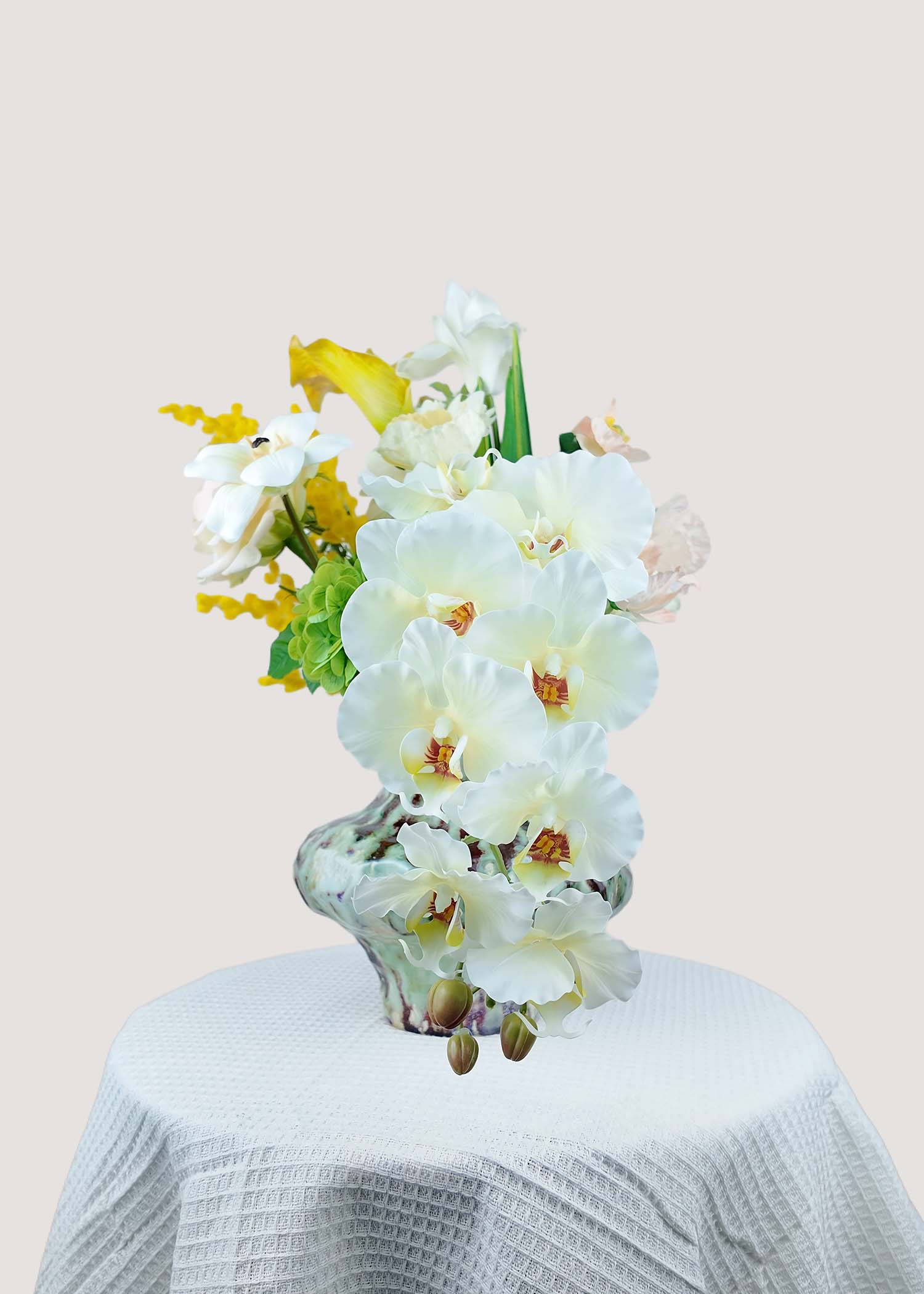 Side view of real touch white lilies and faux anthurium bouquet from right