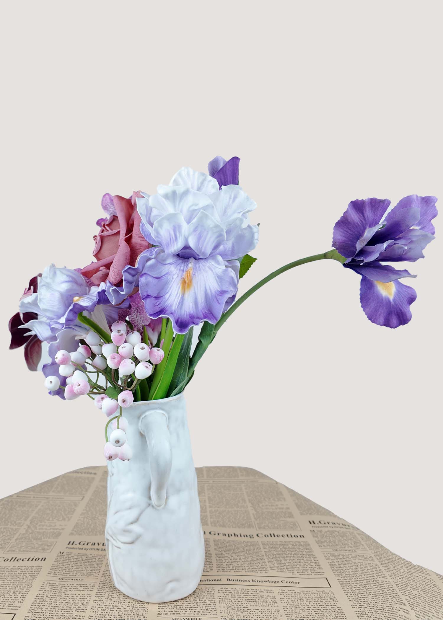 Right angle of petite faux floral centerpiece with mauve rose and orchid.