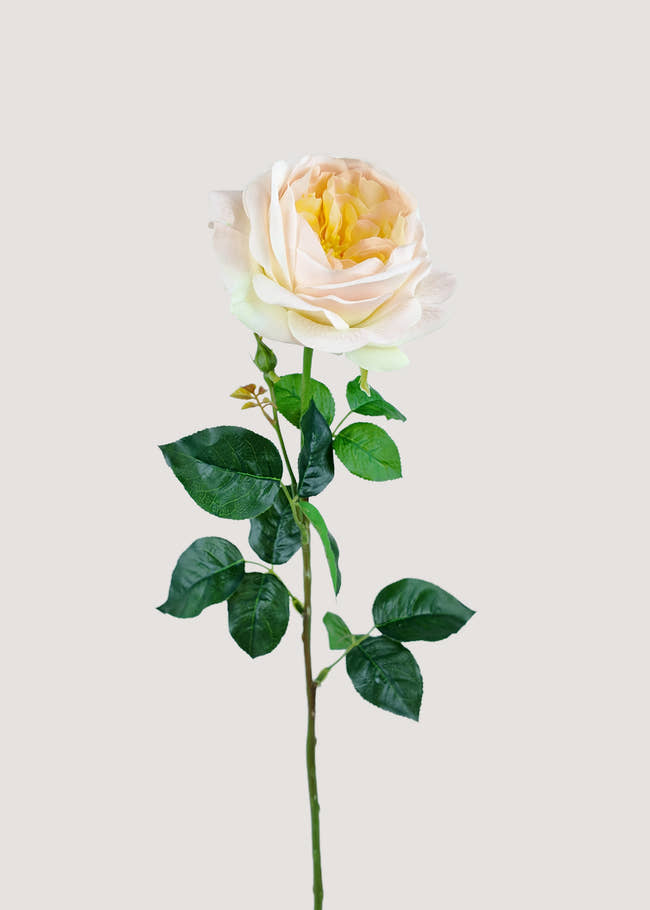 Cream artificial rose stem with soft yellow center and green leaves