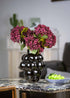 Crimson velvet artificial hydrangea bouquet in black sculptural vase for elegant home decor.