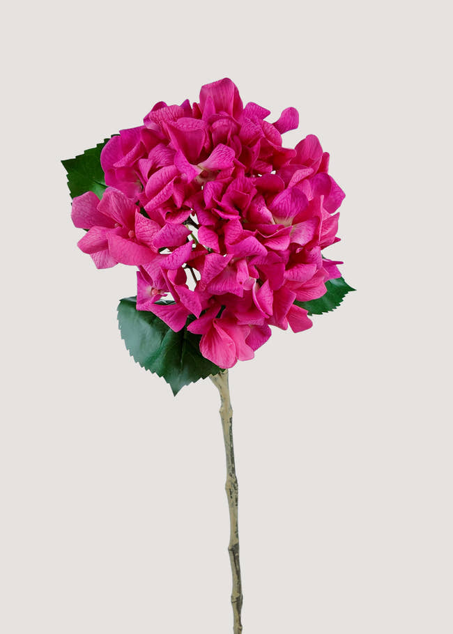 Deep pink artificial hydrangea stem with realistic root and lush green leaves, perfect faux flower for home décor.
