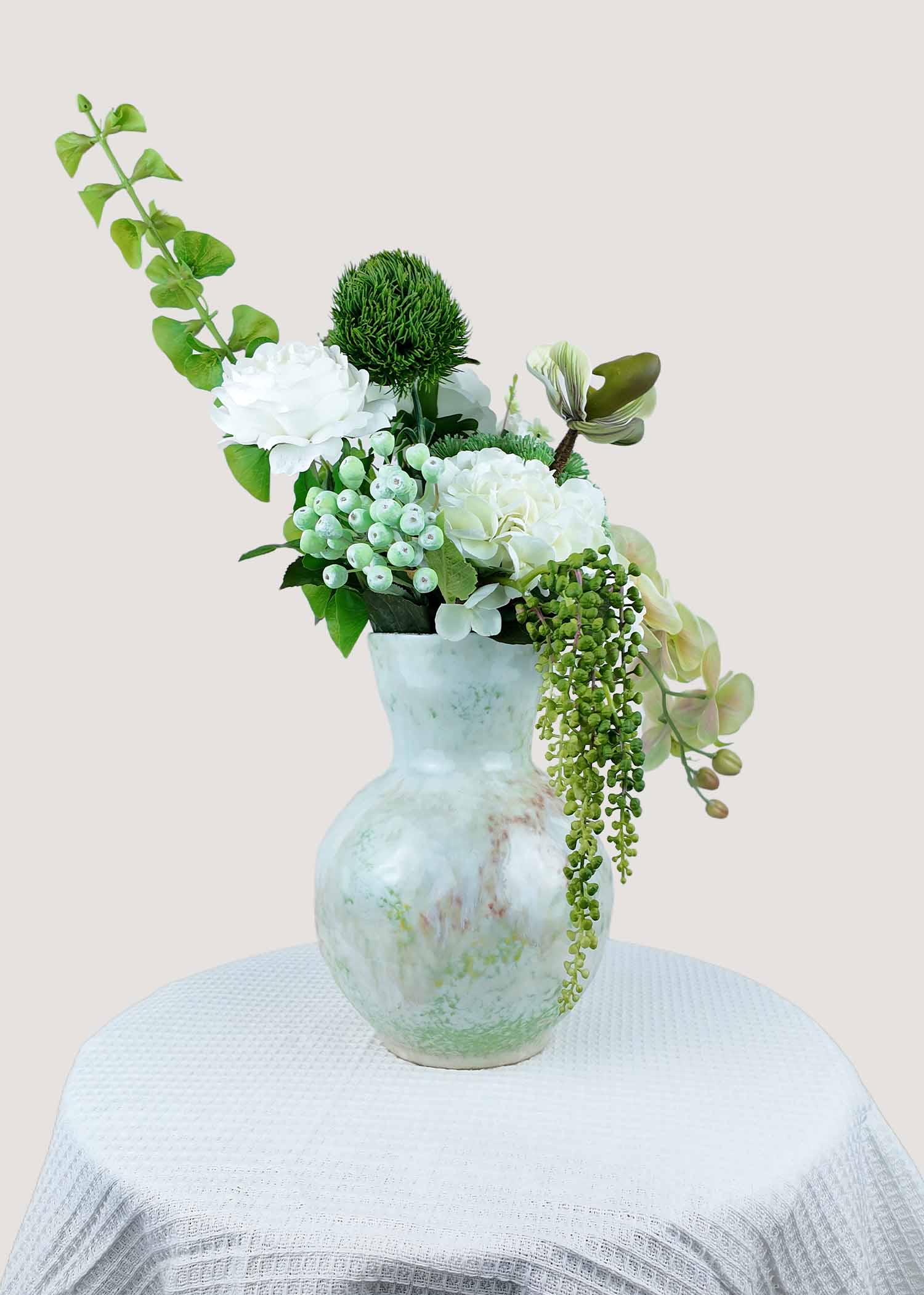 Back view of elegant white and green artificial floral arrangement