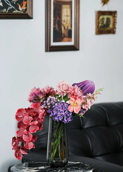 Elegant burgundy rose and orchid artificial flower arrangement displayed in a cozy living room interior – Everblooma luxury faux floral décor