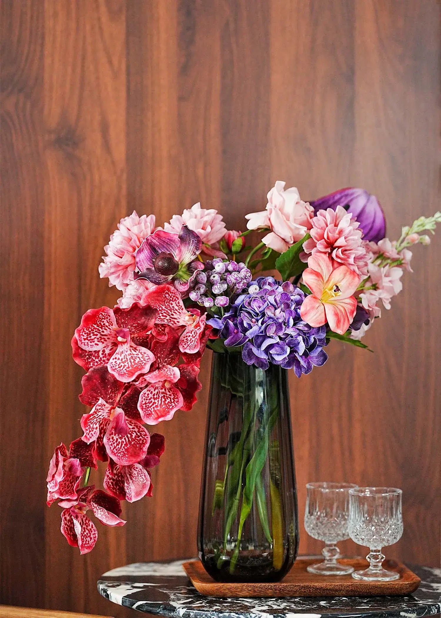 Elegant burgundy rose and orchid artificial flower arrangement displayed in a contemporary home interior with wooden background – Everblooma luxury faux floral design
