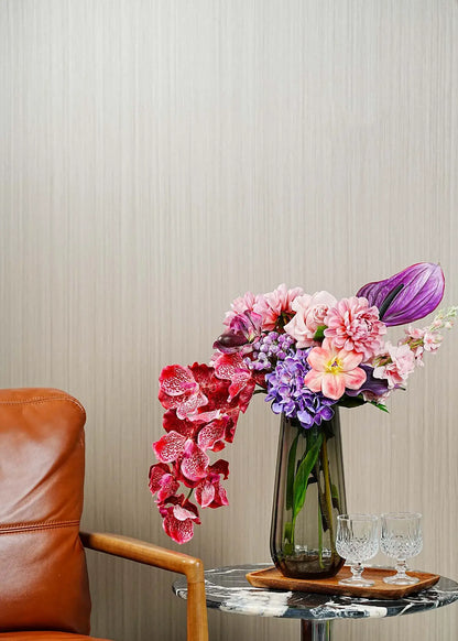 Elegant burgundy rose and orchid artificial flower arrangement styled in a modern living room with glass vase – Everblooma luxury faux floral décor