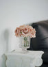 Mauve artificial rose bouquet in crystal vase on marble table, elegant home decor by Everblooma