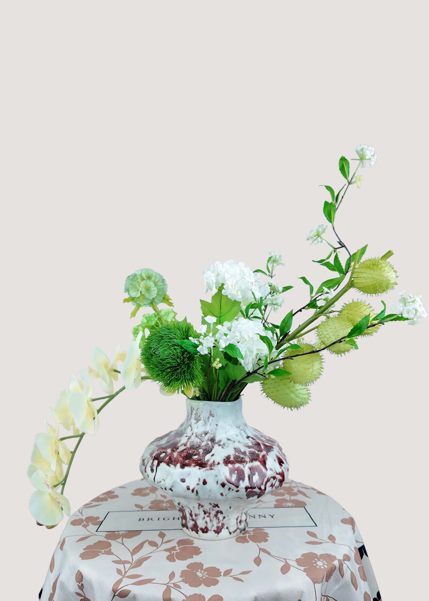 Back view of faux orchid and green textured floral design for home décor.