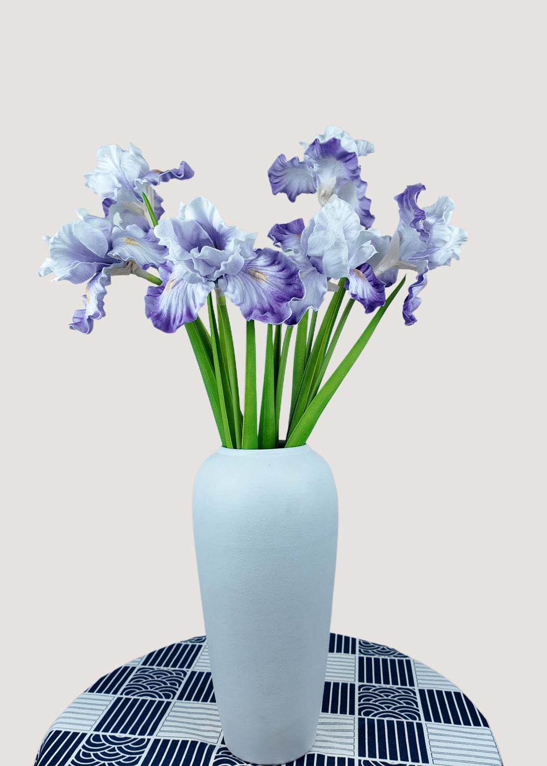 Purple and white artificial iris flower bouquet in vase