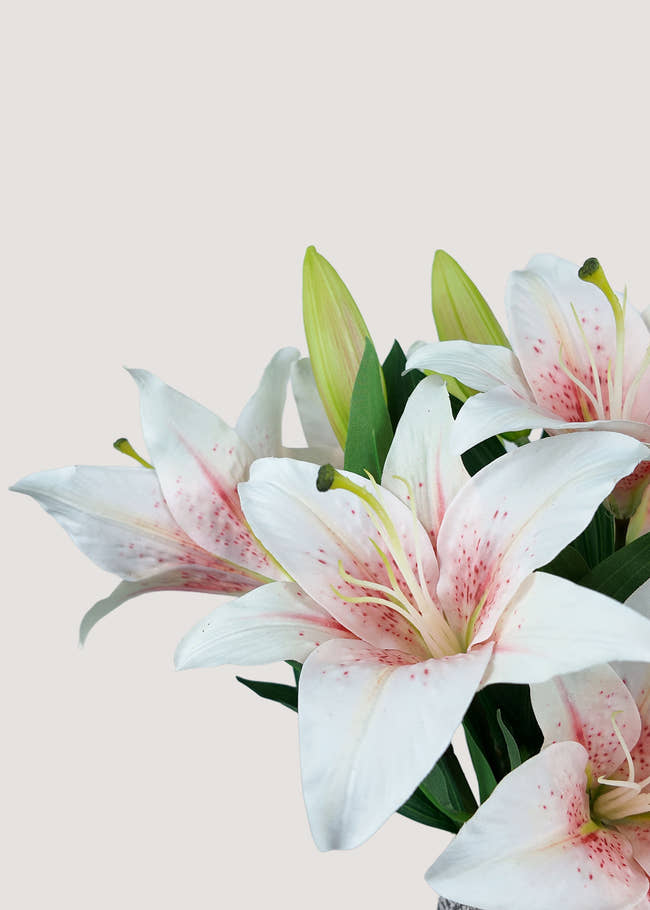 Close-up of real touch pink and white faux lily petals