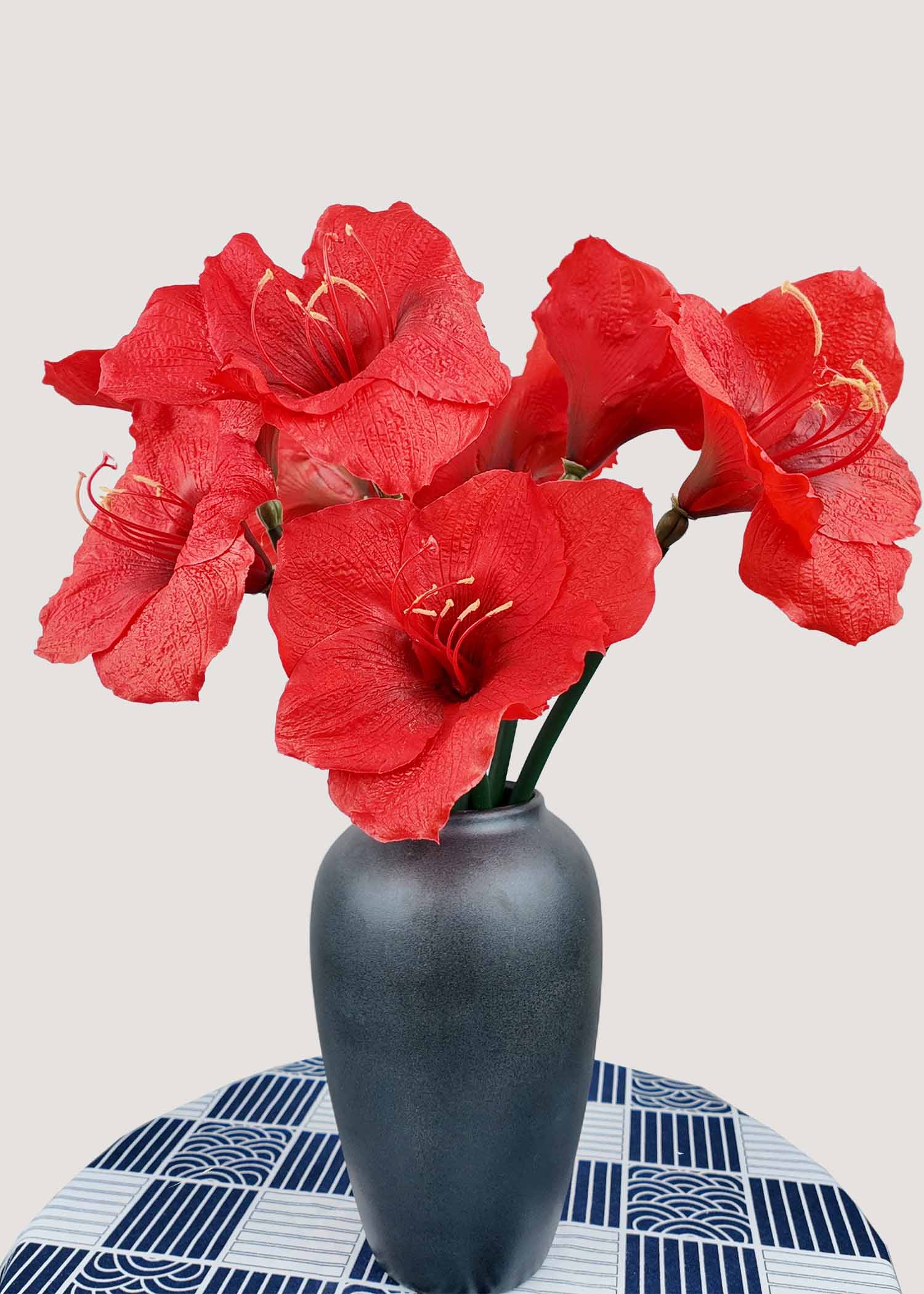 Red amaryllis artificial flower bouquet in vase