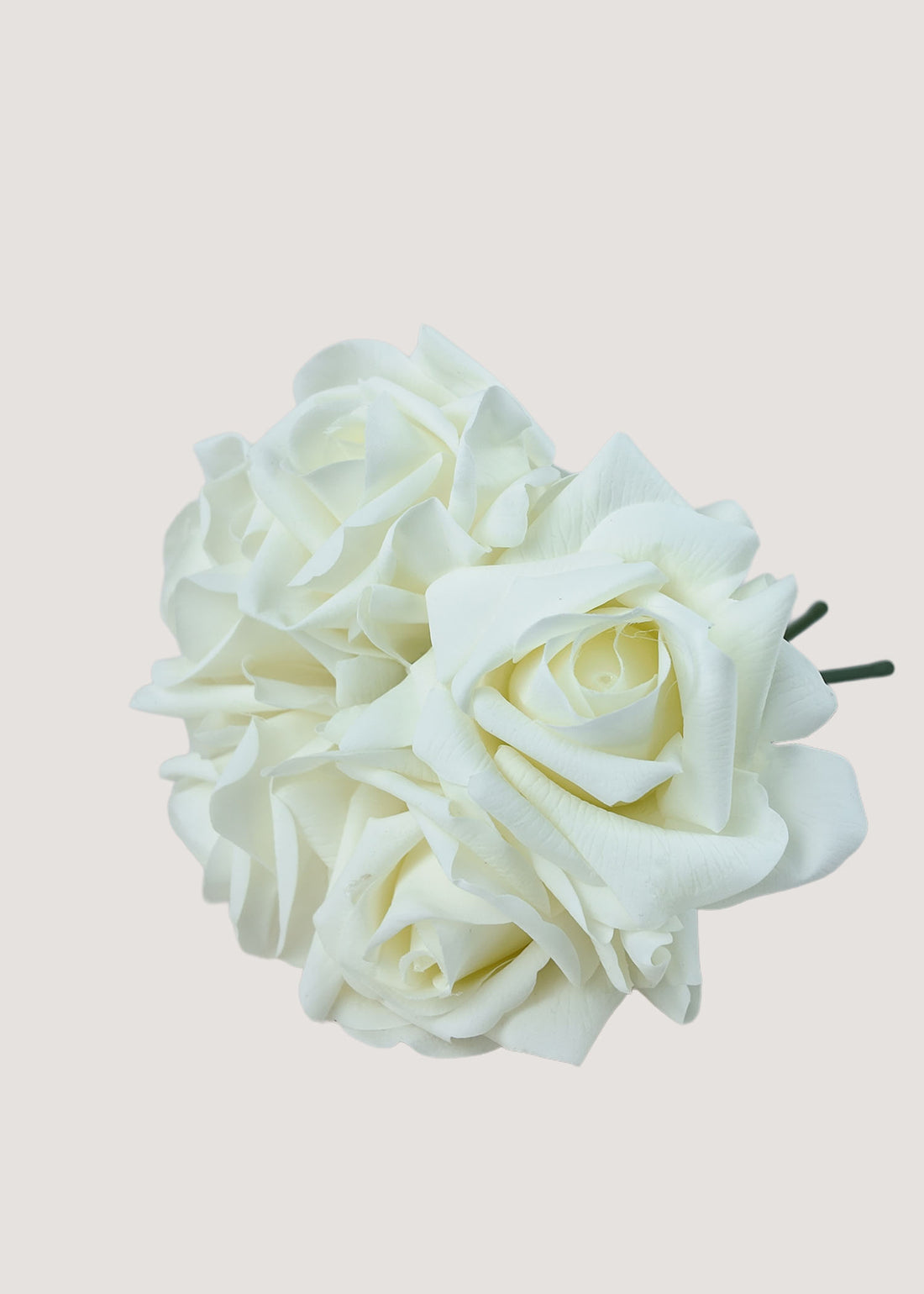 Close-up detail of white artificial rose petals, showcasing realistic texture and lifelike silk flower design.