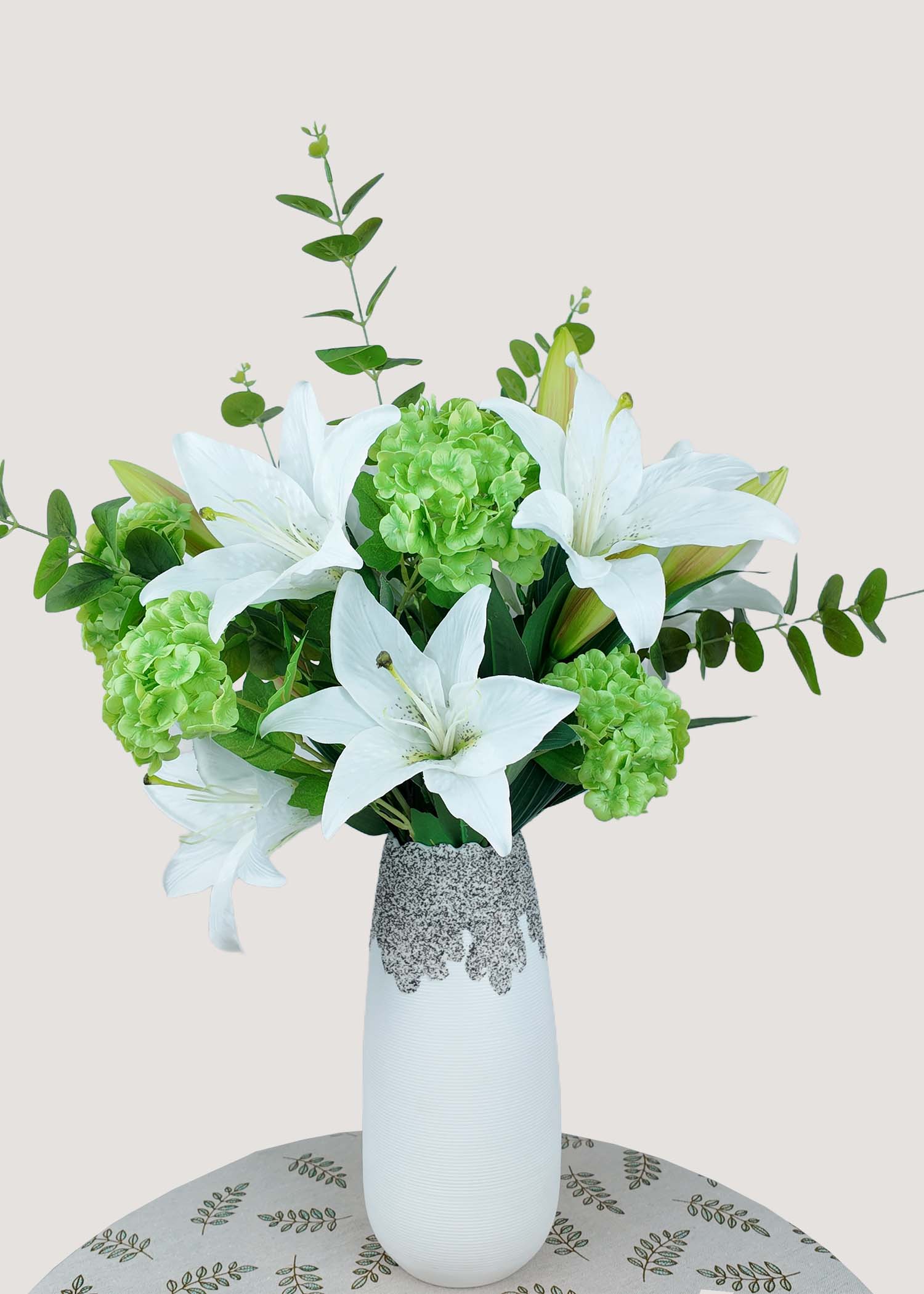 Elegant white faux lilies and green hydrangeas in vase – luxury artificial floral arrangement