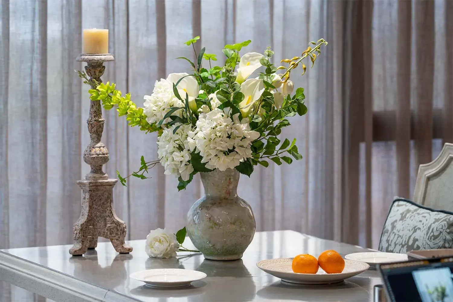 Elegant white artificial floral centerpiece in ceramic vase for home décor