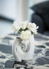 White artificial rose bouquet in modern sculptural ceramic vase on marble table, elegant home decor by Everblooma