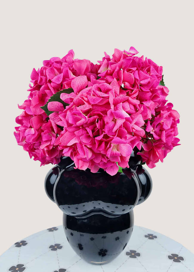 Vibrant hot pink artificial hydrangea bouquet in modern black vase