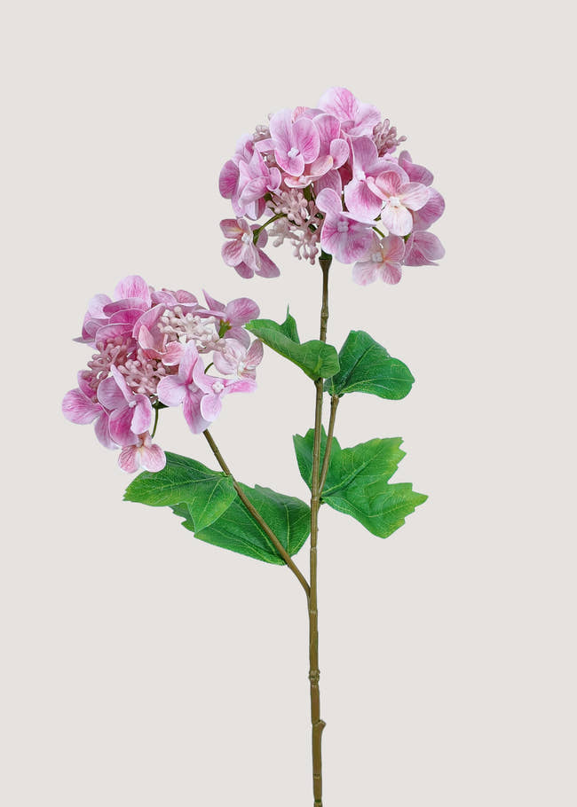 Artificial pink hydrangea stem with soft petals and green leaves