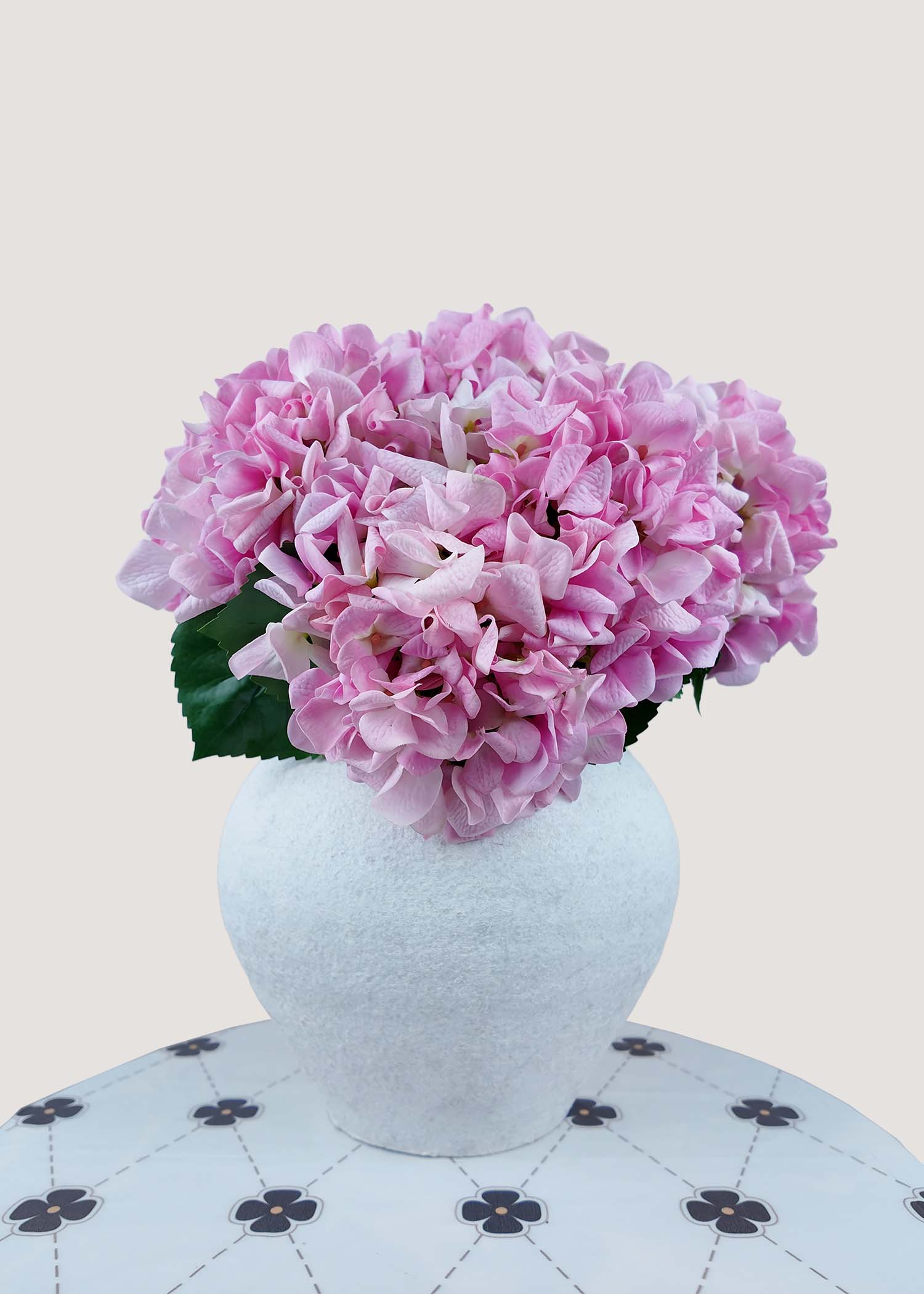 Pink artificial hydrangea bouquet with lush silk flowers in vase