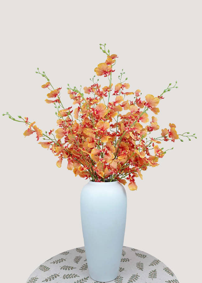 Vibrant orange artificial dancing orchid bouquet in tall vase – faux oncidium orchid stems for home décor
