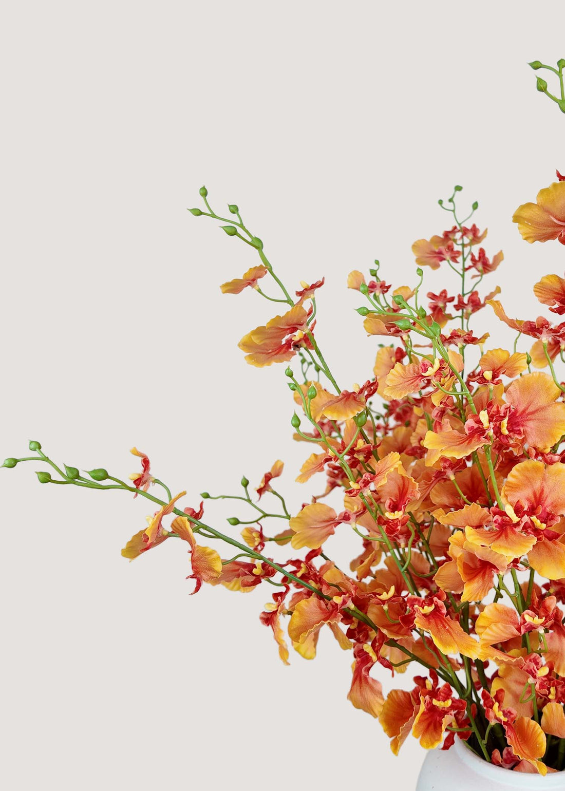 Close-up detail of realistic silk orange dancing orchid blooms, lifelike faux flowers
