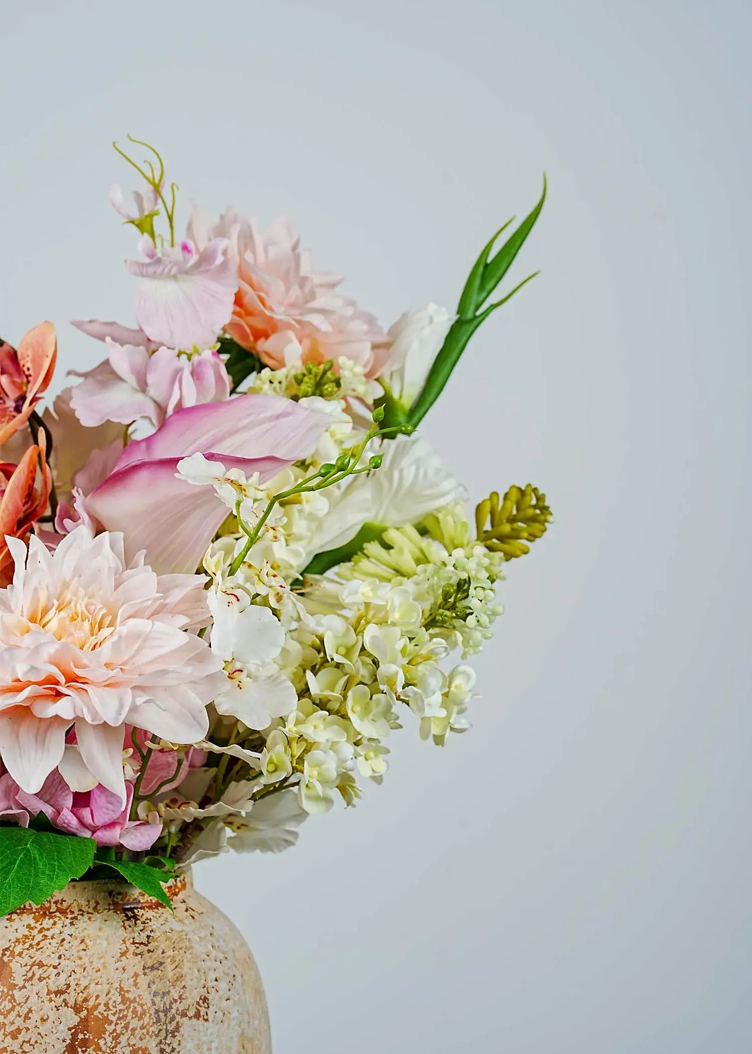 Close-up of peach blush artificial flower arrangement showing dahlias, orchids, calla lilies, and white lilacs with lifelike texture – Everblooma faux florals