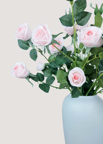 Close-up detail of pink artificial rose bouquet – delicate silk petals and bud