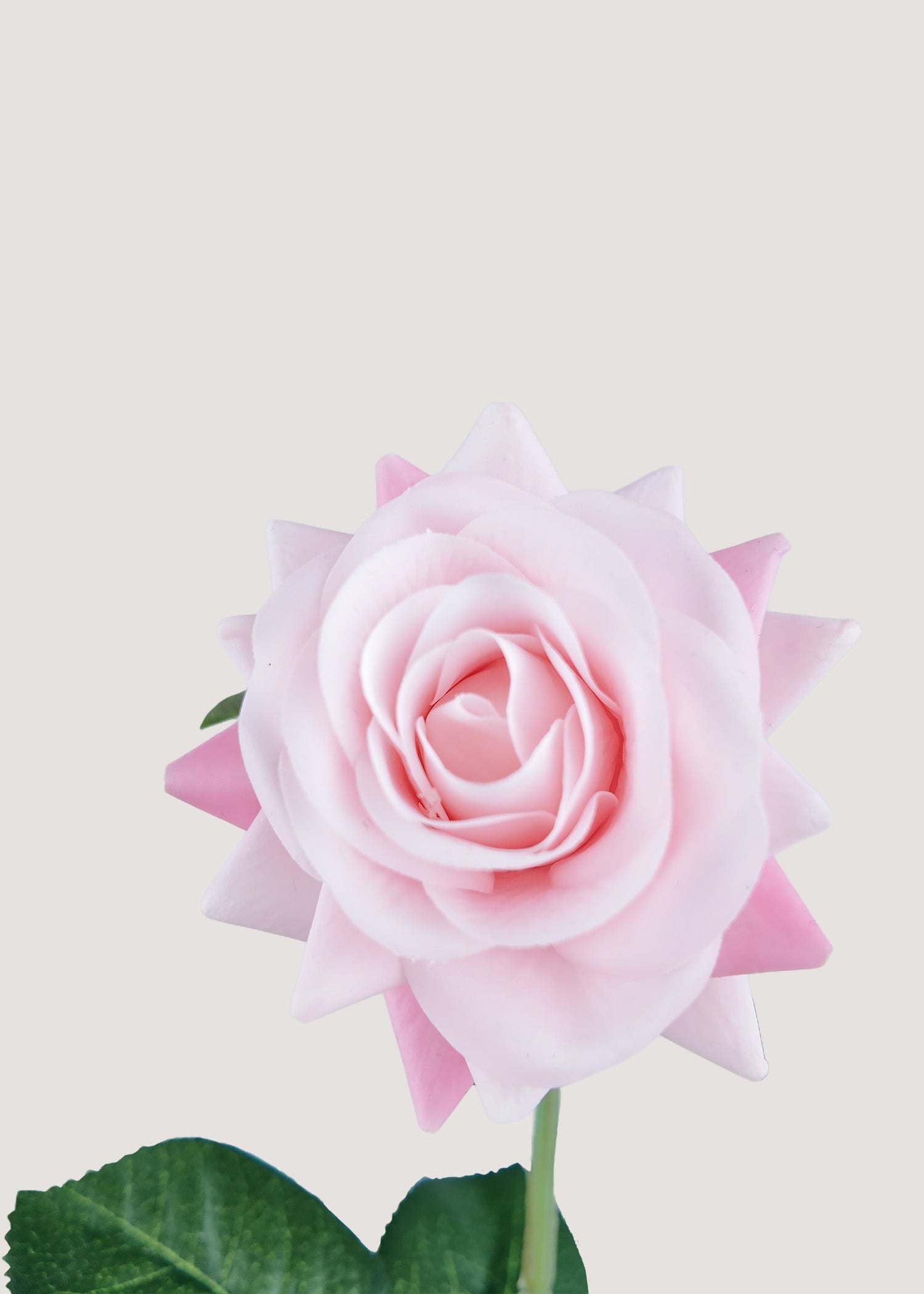 Soft pink artificial rose stem with lifelike petals and green leaves details
