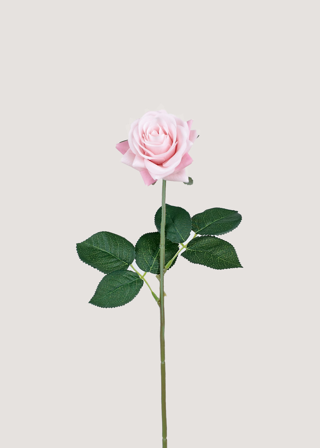 Soft pink artificial rose stem with lifelike petals and green leaves