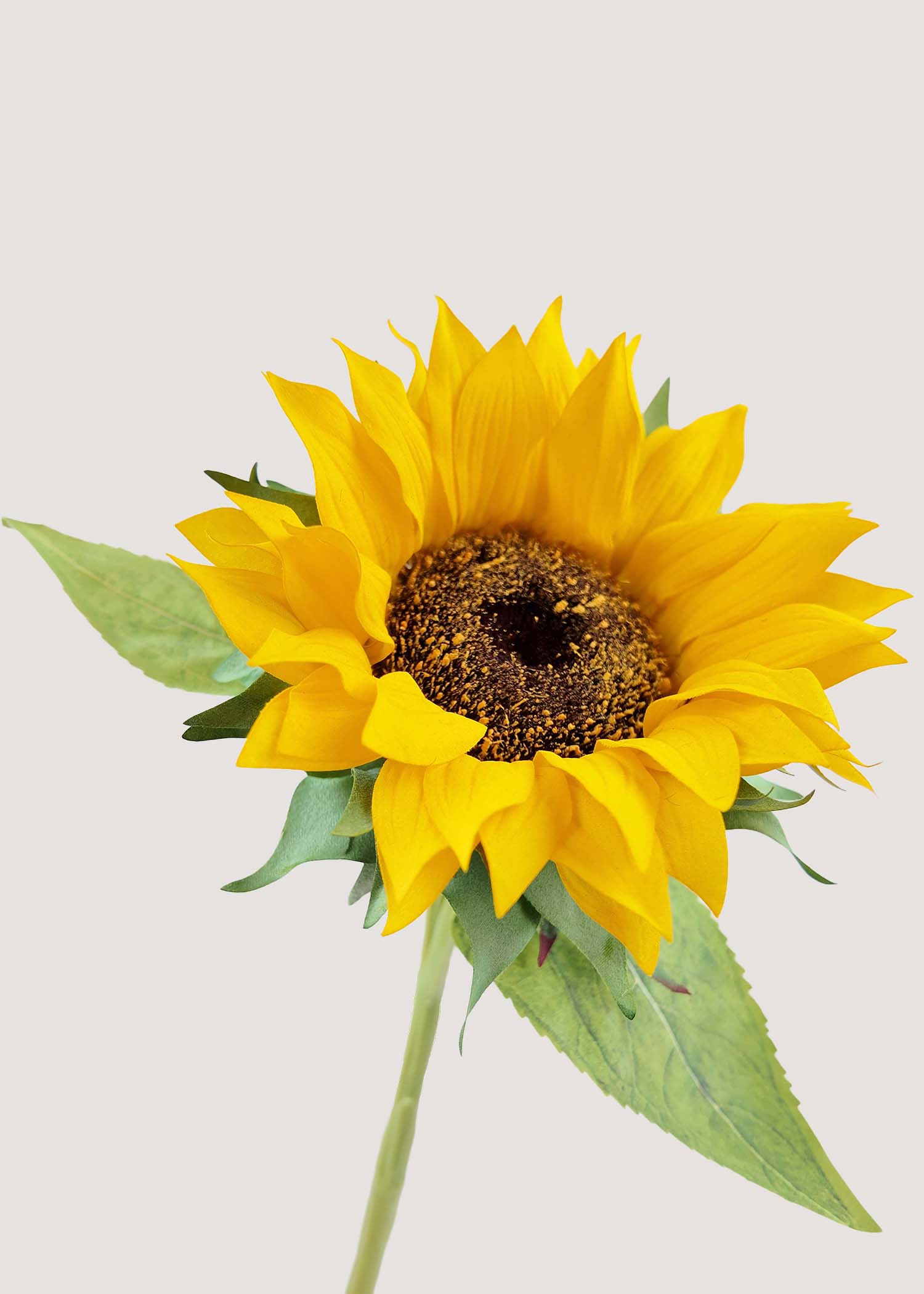 Close-up detail of artificial sunflower with realistic yellow petals and textured center