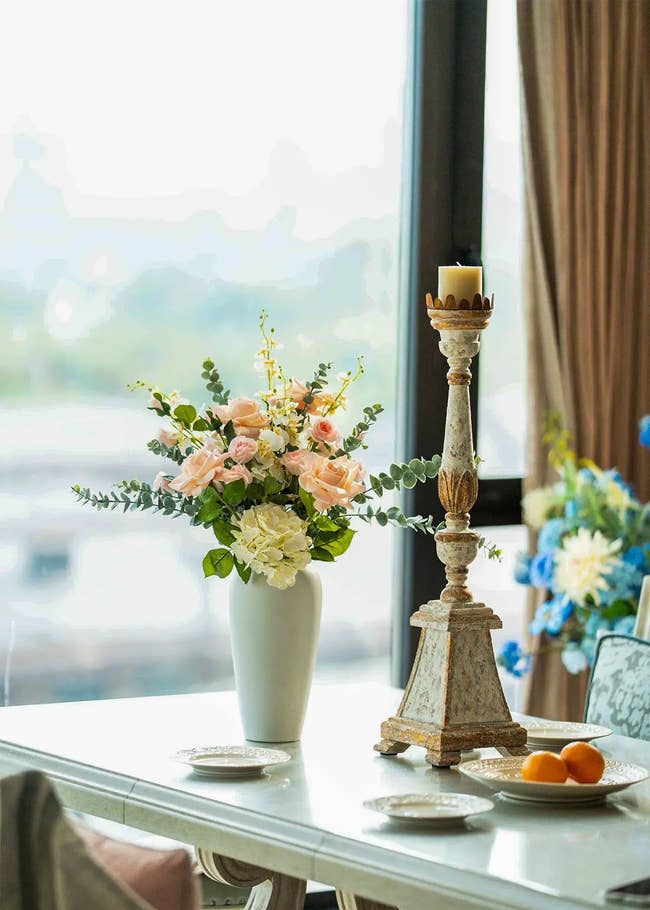Real Touch blush roses and white hydrangea faux floral arrangement in a ceramic vase on a bright dining table, elegant home decor centerpiece.