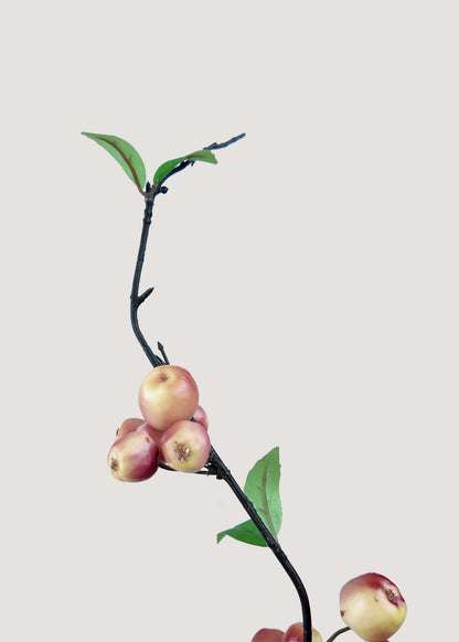 Close-up detail of realistic ripe red-yellow apple fruits on faux branch