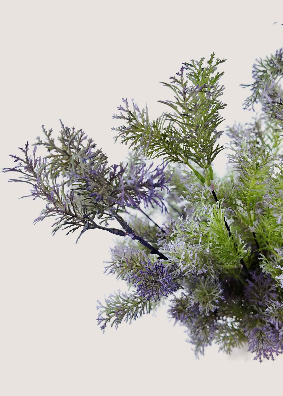 Close-up showing realistic snow-dusted details on faux floral bouquet