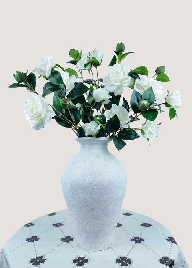 White artificial camellia bouquet with buds in vase for home décor