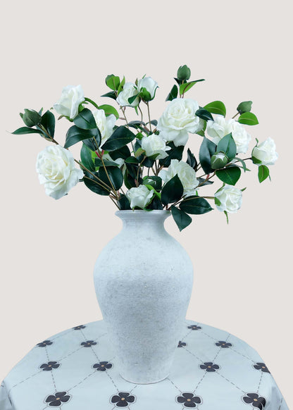 White artificial camellia bouquet with buds in vase for home décor